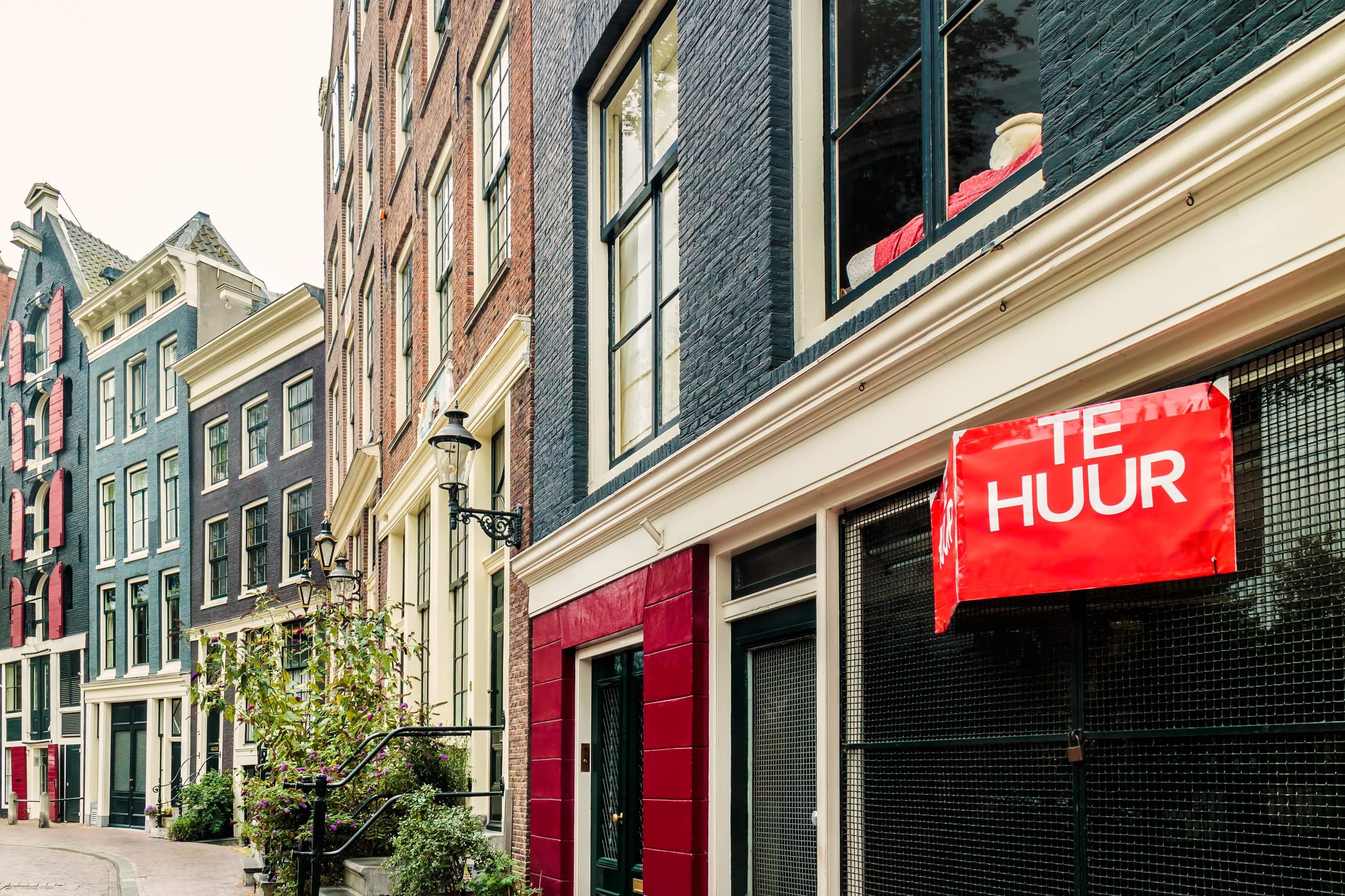 Dutch for rent sign on a canal house in Amsterdam