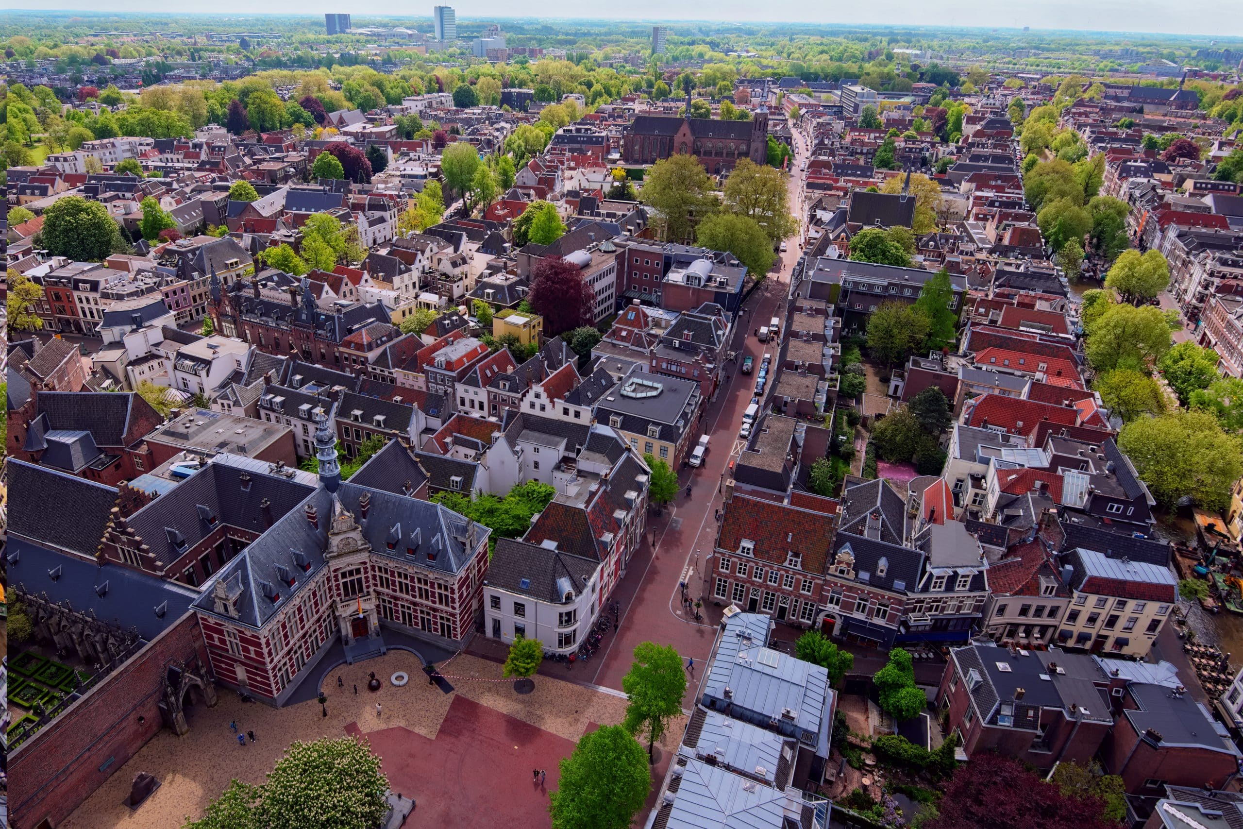 Arial view from the top of the tower of the St. Martins Cathedral at sunny day. Beautiful view of streets with ancient buildings of Utrecht. Popular travel destination in the Netherlands.